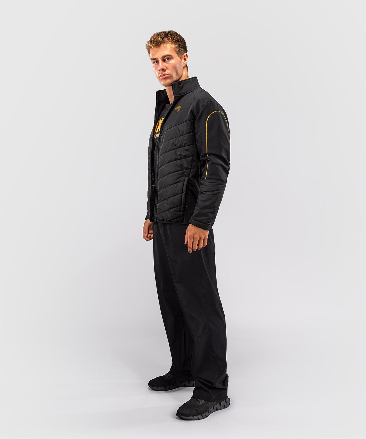 Venum Paddock Chaqueta softshell - Negro/Dorado